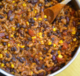 A bowl of chile pasta with vegetables mixed in