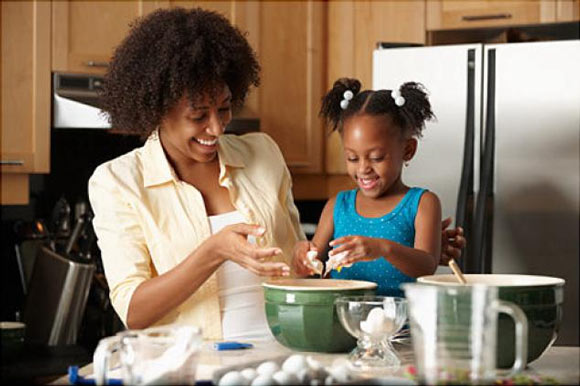 a mom cooking with her daughter